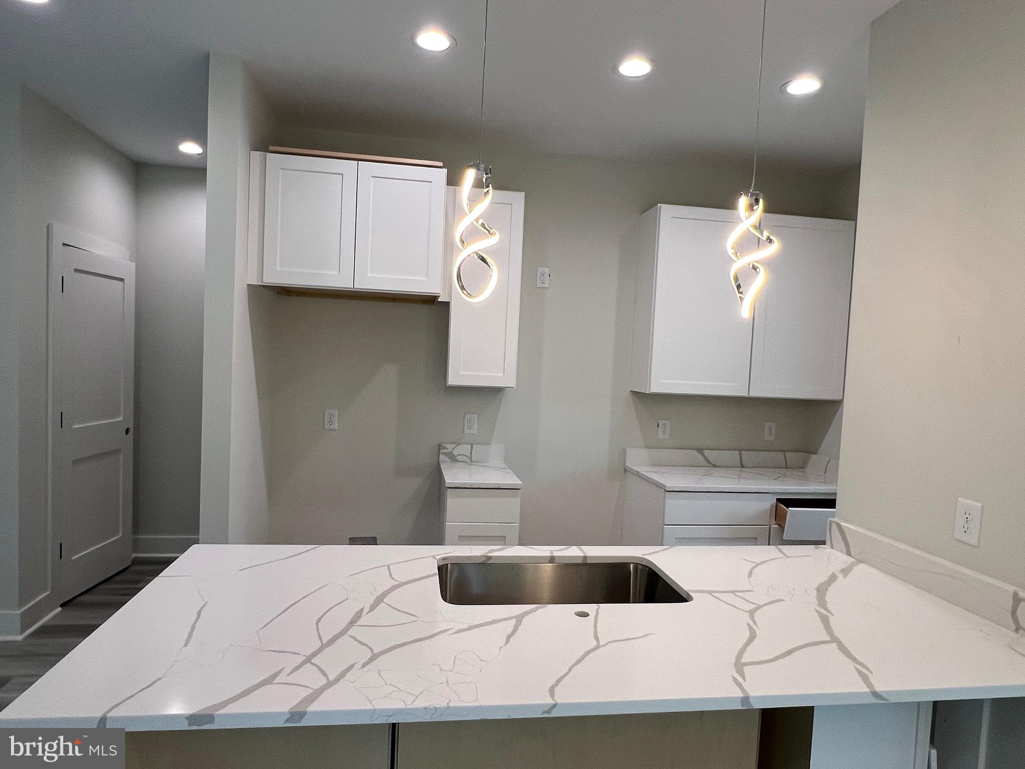 175 Rose Way Colonial Beach, VA 22443 - Photo 12 of 33 a kitchen with cabinets and white stainless steel appliances