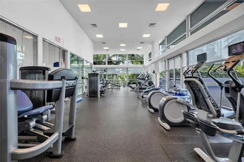 a gym room with lots of gym equipment
