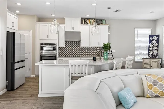 a living room with furniture and kitchen view
