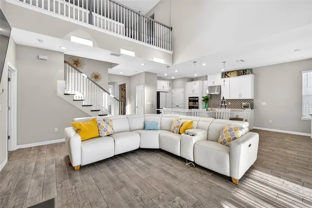 a living room with furniture and kitchen view