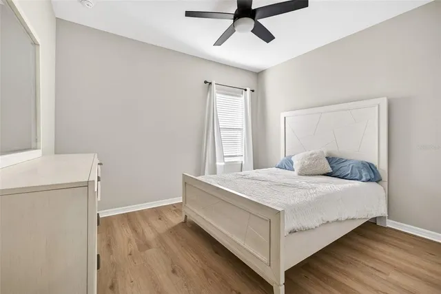 a living room with furniture a flat screen tv and wooden floor