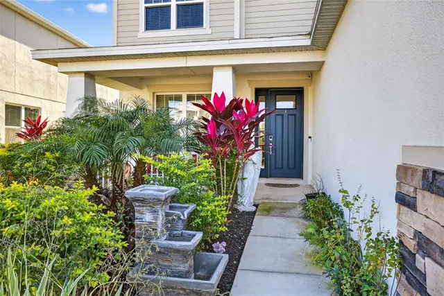 a view of a house with potted plants