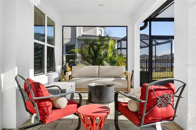 a view of a swimming pool with a lawn chairs and potted plants