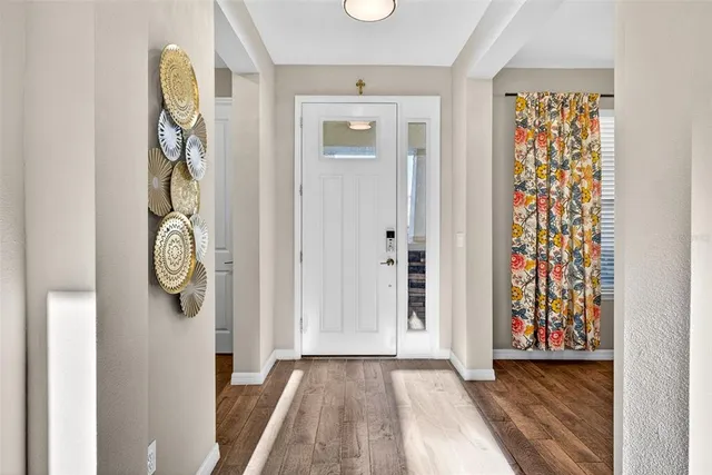 a view of an entryway with wooden floor