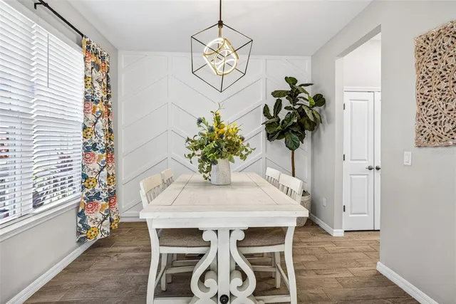 a view of a dining room with furniture and a potted plant
