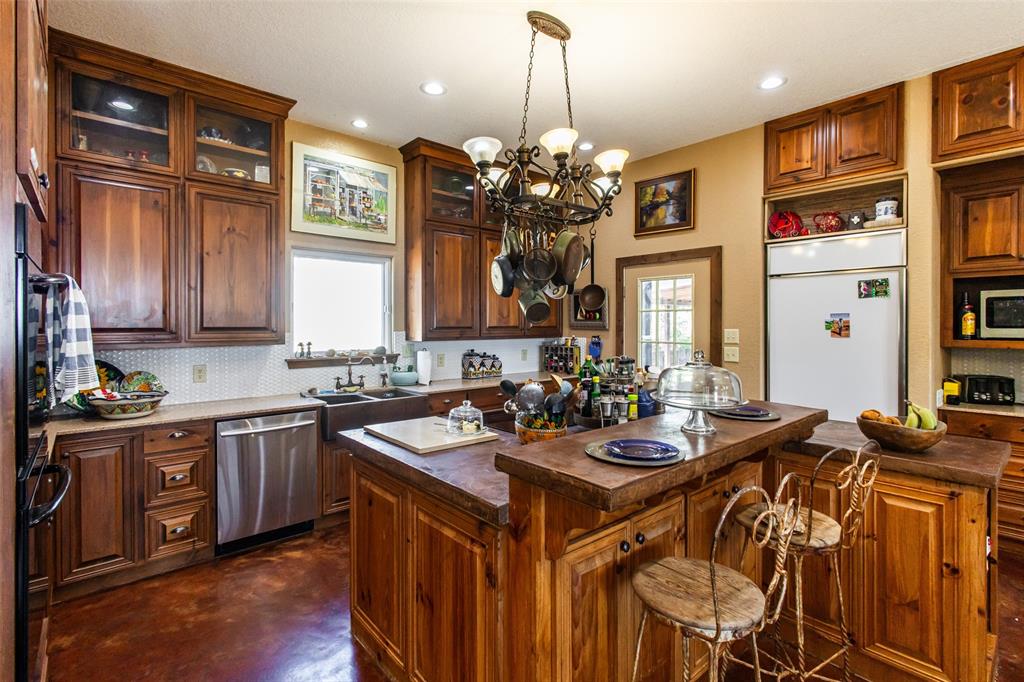 1775 Sunset Mountain Road Lipan, TX 76462 - Photo 10 of 34 a kitchen with a sink stove and cabinets