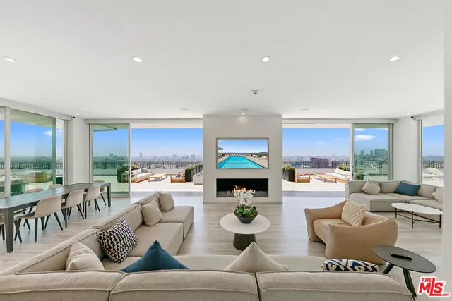 a living room with furniture and large windows