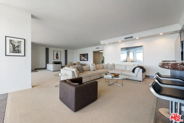 a lobby with furniture and floor to ceiling window