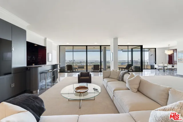a dining room with furniture a chandelier and wooden floor