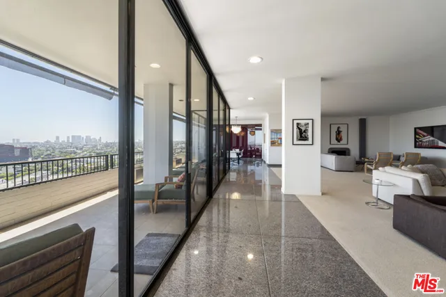 a view of a dining room with furniture a chandelier and wooden floor