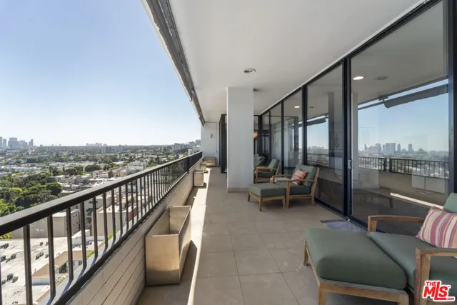 a bathroom with a granite countertop toilet and sink