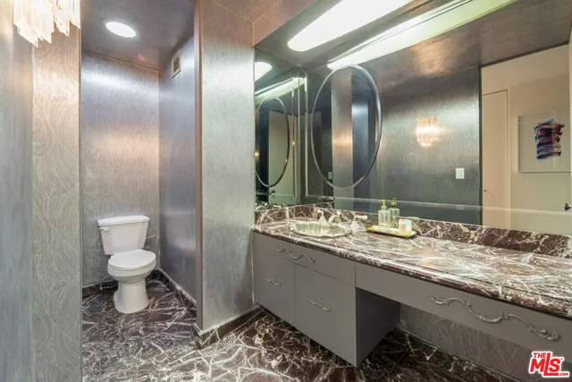 a spacious bedroom with a bed and a flat screen television