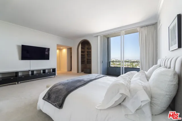 a spacious bathroom with a tub sink and mirror