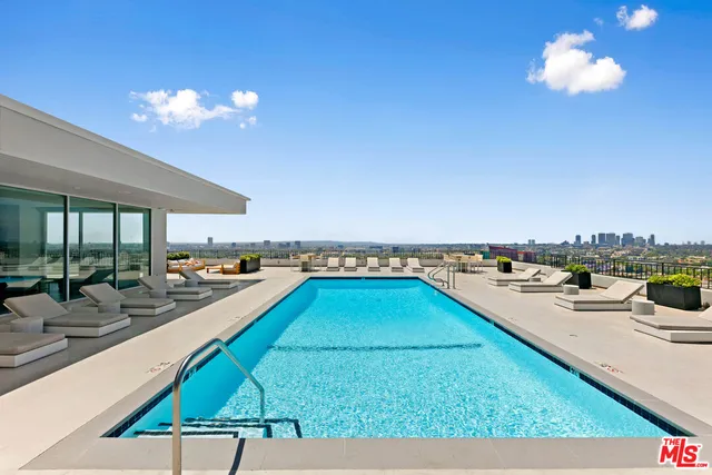 a view of a swimming pool and lounge chairs