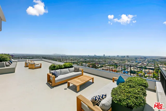 a living room with furniture kitchen and a large window