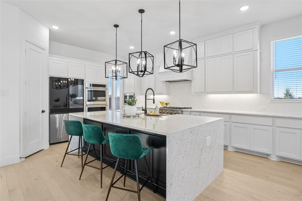 2800 Count Fleet Way Celina, TX 75009 - Photo 15 of 34 a kitchen with stainless steel appliances granite countertop a sink and refrigerator