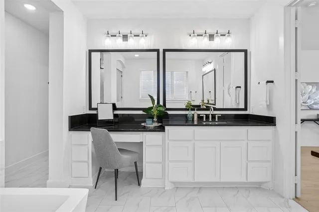 a bathroom with a double vanity sink a mirror and a shower