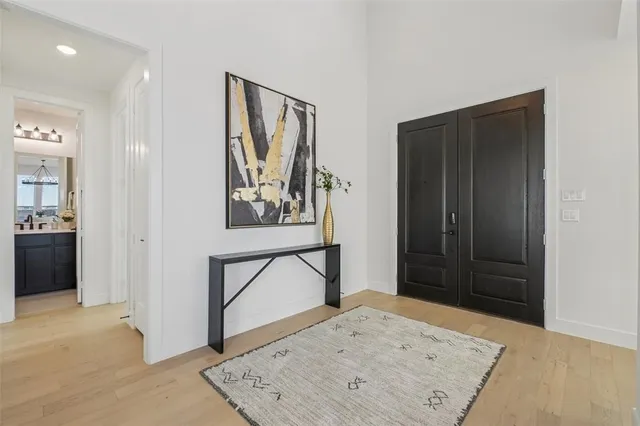 a view of staircase with white walls and a painting on the wall