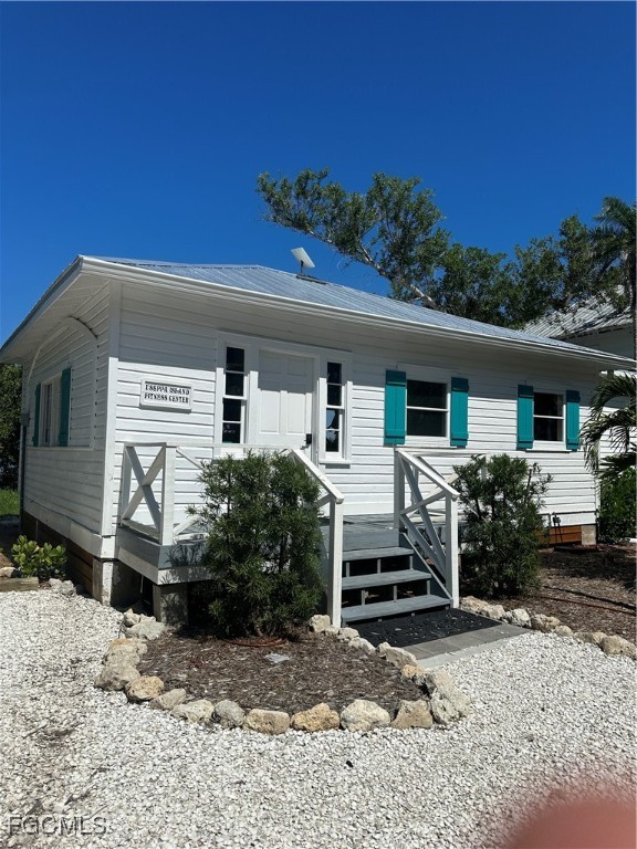 327 Useppa Island Bokeelia, FL 33922 - Photo 8 of 13 a front view of a house with a yard