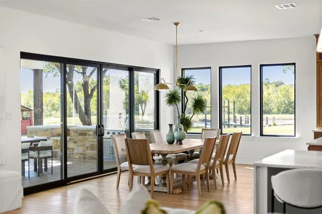 a view of a dining room with furniture window and wooden floor