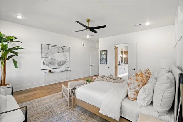 a bedroom with a bed and a painting on the wall