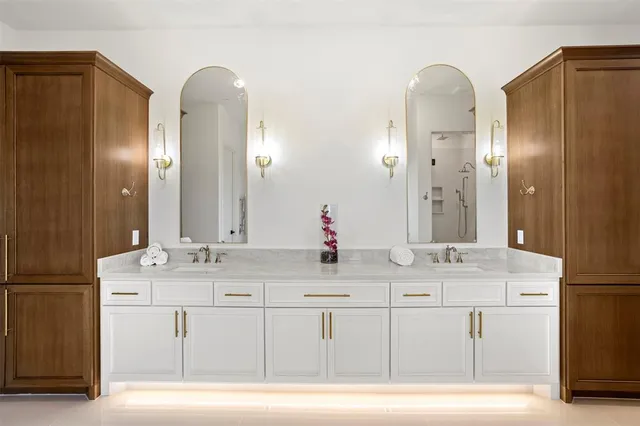 a bathroom with double sink and a mirror