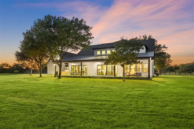 a living room with patio furniture and a large garden