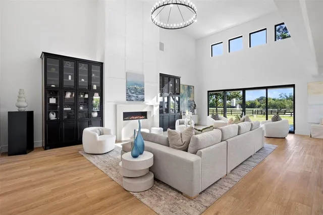 a living room with furniture and a floor to ceiling window