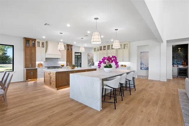 a kitchen with granite countertop kitchen island stainless steel appliances a dining table and chairs