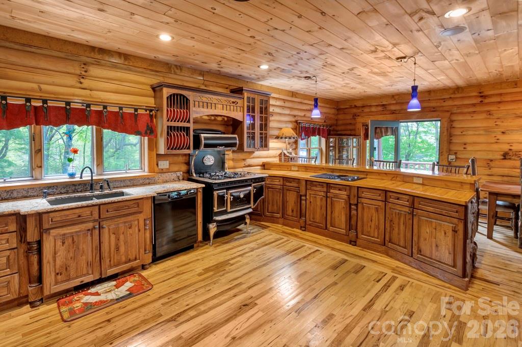 35 Falcon Crest Loop Maggie Valley, NC 28751 - Photo 11 of 46 a kitchen with stainless steel appliances granite countertop a stove a sink and a microwave