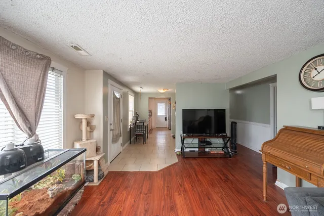 a view of a livingroom with furniture and a flat screen tv