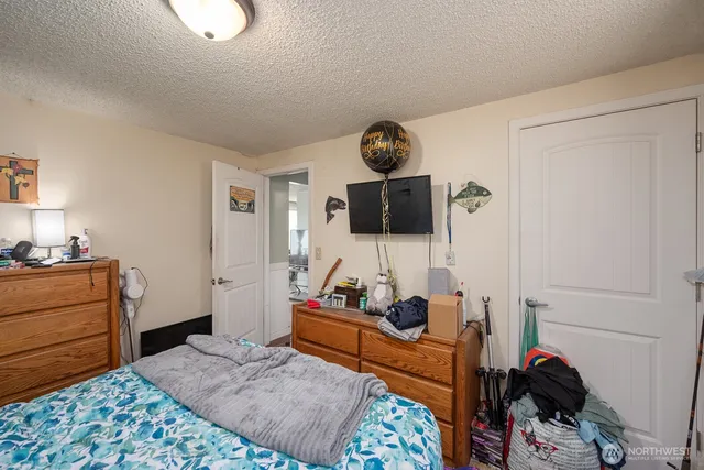 a bedroom with a bed and cabinets