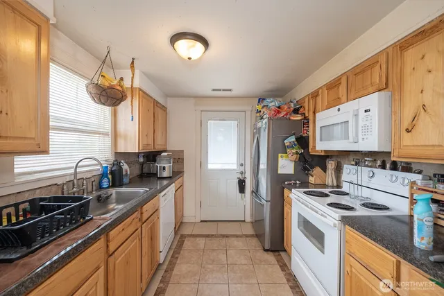 a kitchen with a sink stove and refrigerator