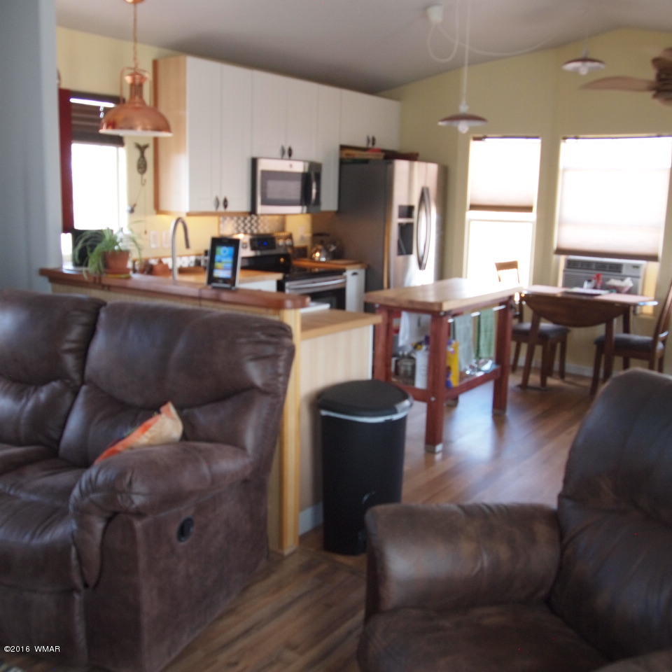 4214 Indian Bend Road Snowflake, AZ 85937 - Photo 13 of 43 a living room with furniture a large window and a dining table