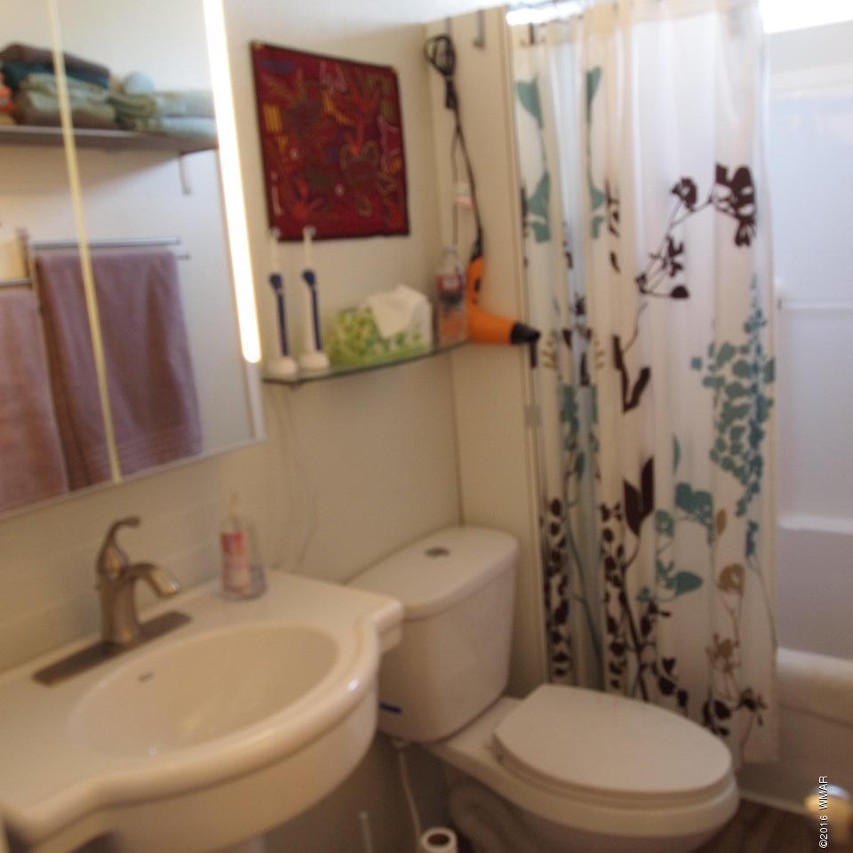 4214 Indian Bend Road Snowflake, AZ 85937 - Photo 18 of 43 a white toilet sitting next to a bathroom sink