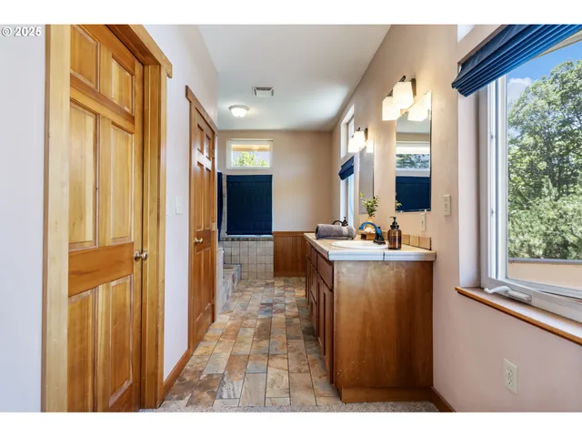 a bathroom with a sink mirror and a bathtub