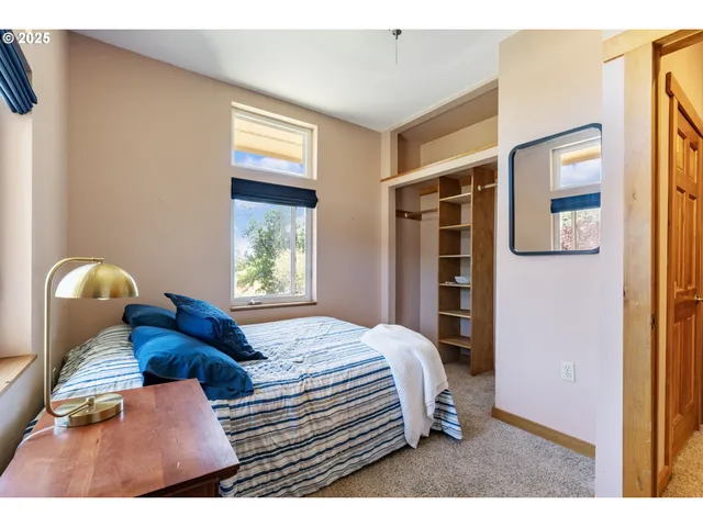 a bedroom with a bed and a painting on the wall