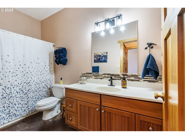 a bathroom with a sink vanity mirror and toilet