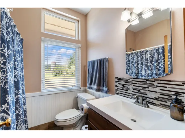 a bathroom with a sink a toilet and mirror