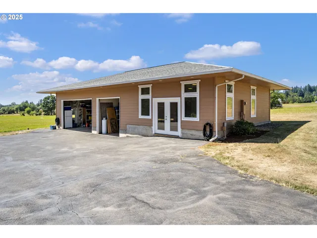a front view of a house with a yard and seating space