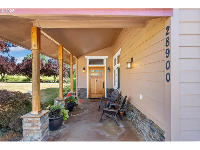 a porch with chairs and a table