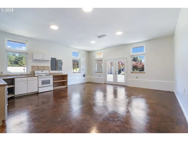 a view of a kitchen with furniture and wooden floor