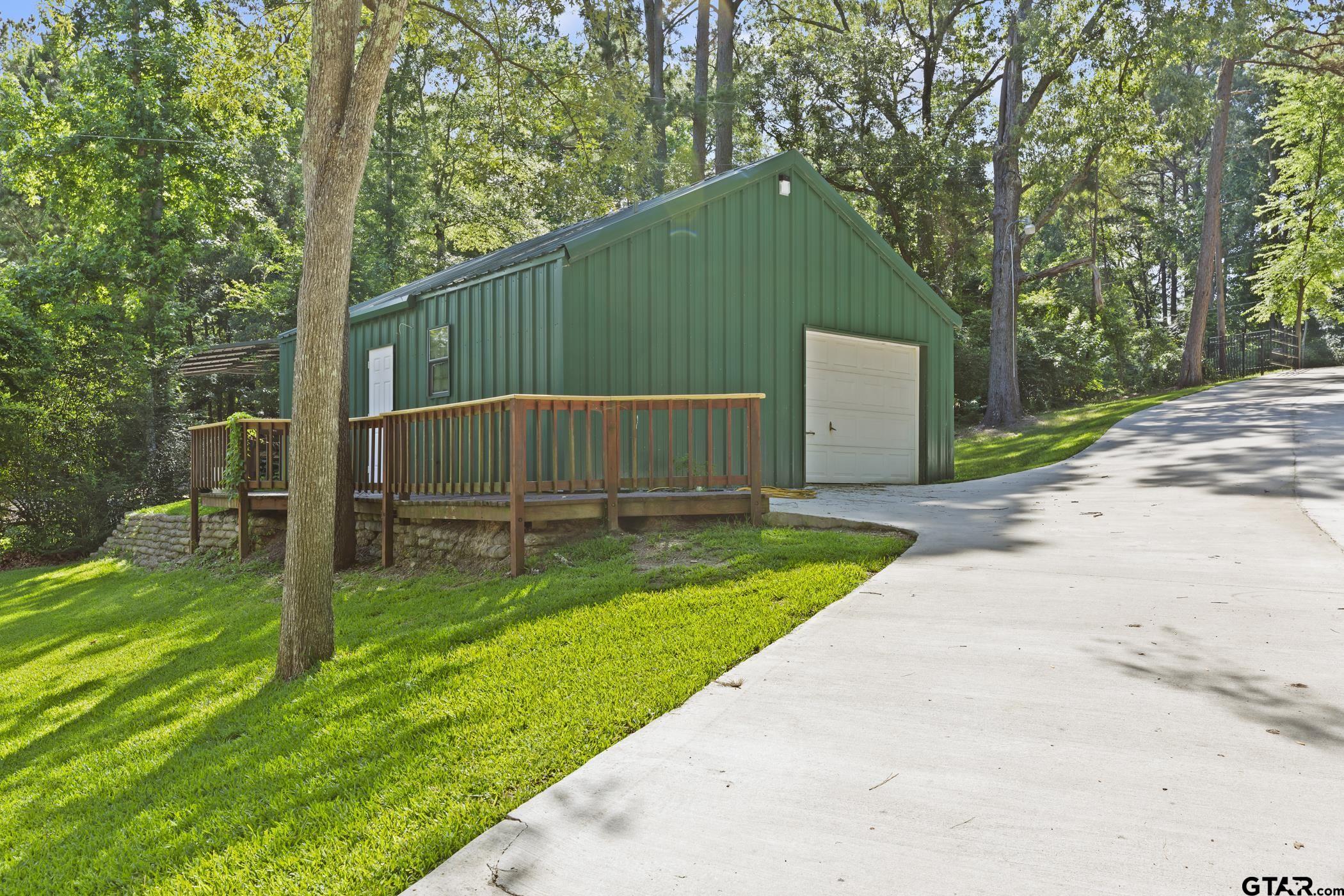 18630 Eastside Road Troup, TX 75789 - Photo 32 of 47 a backyard of a house with wooden fence and trees