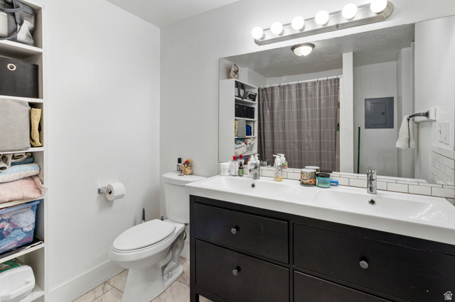 386 North 500 East Provo, UT 84606 - Photo 8 of 24 Bathroom featuring double vanity, a shower with curtain, and electric panel