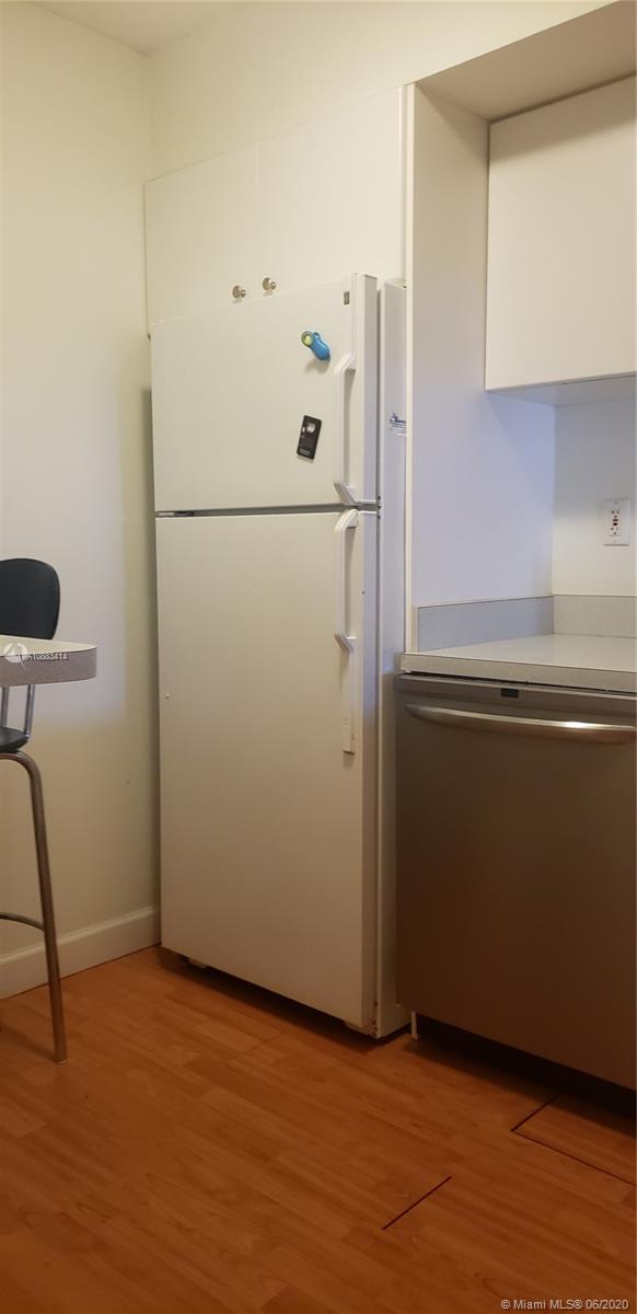 Glenvar Heights Miami, FL 33155 - Photo 12 of 12 a kitchen with a refrigerator and a stove