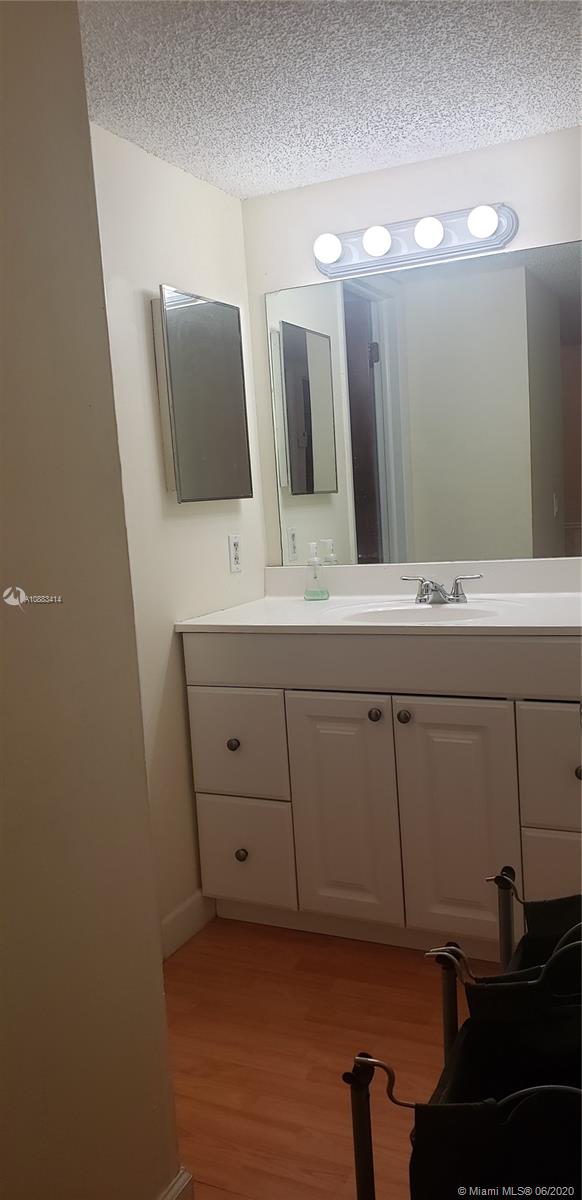 Glenvar Heights Miami, FL 33155 - Photo 8 of 12 a bathroom with a double vanity sink and a mirror