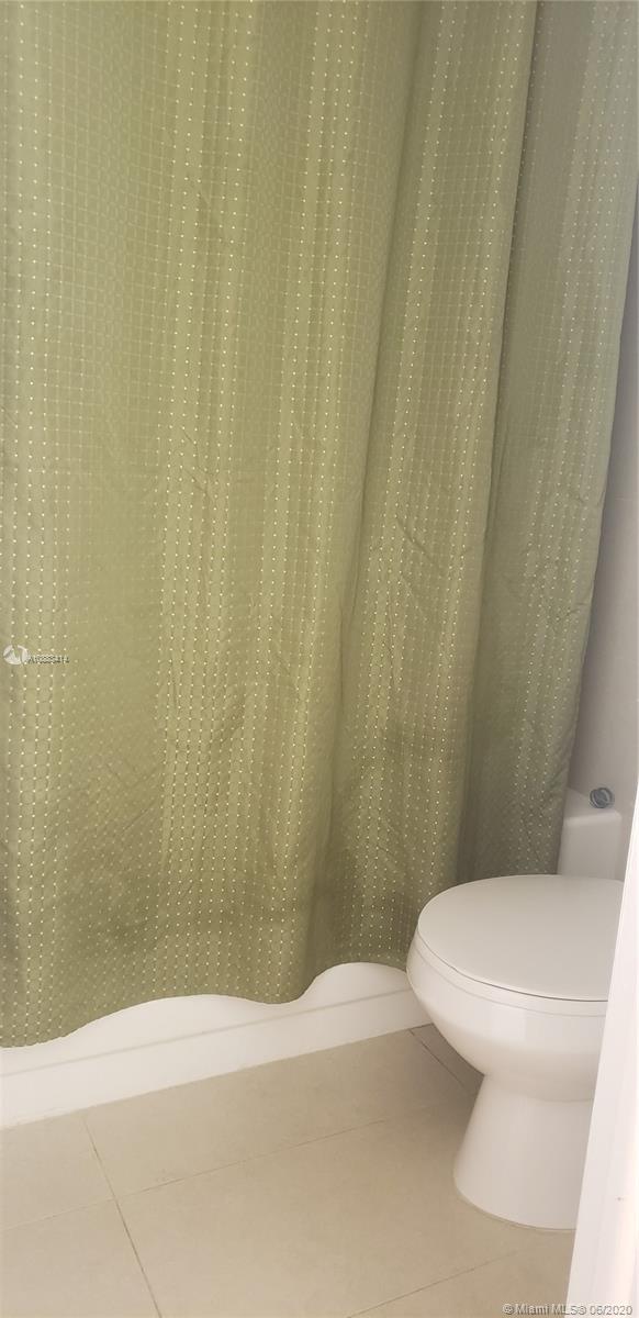 Glenvar Heights Miami, FL 33155 - Photo 9 of 12 a white toilet sitting next to a white wall