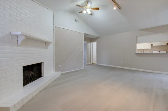 a view of empty room with fireplace