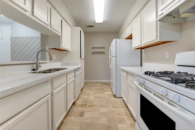 a kitchen with stainless steel appliances a sink and a stove