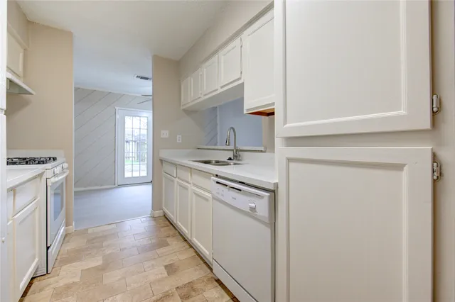 a kitchen with a sink stove and refrigerator